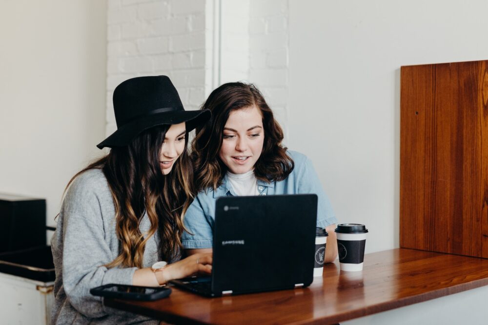 Two Girls Reading Small Business Blogs